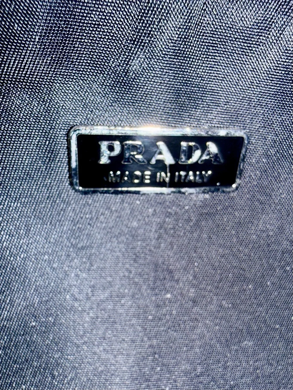 Prada Black Nylon & Leather Bag with Embossed Prada logo.
